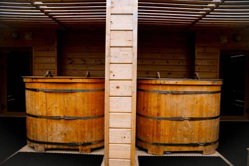 a pair of wooden barrels in a room at Wyndham Residences Aqkol in Akkol'