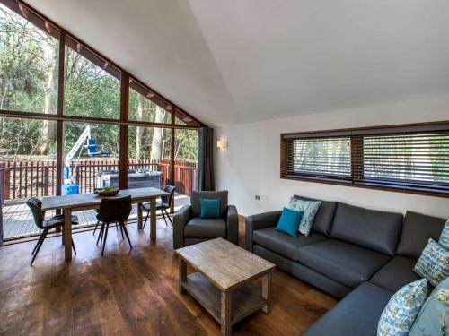 a living room with a couch and a table at Strathyre, Ben Ledi Cabins - Forest Holidays in Callander
