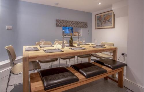 a dining room with a table and some chairs at Calebs Cottage- Solva harbour in Solva