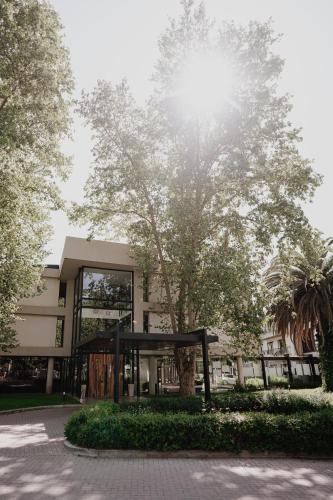 a building with a tree in front of it at La Urumpta Hotel, AKEN MIND in Río Cuarto