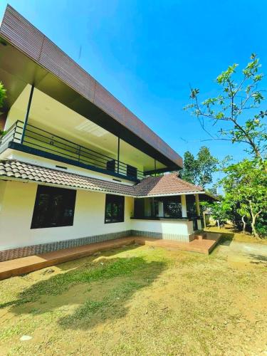 a house with a pitched roof at The zerai private villa in Vythiri