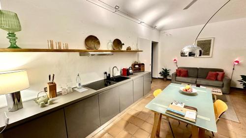 a kitchen and living room with a table and a couch at La Fornace in Alessandria