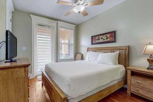 a bedroom with a bed and a flat screen tv at Miramar Beach Villas #110 in Destin