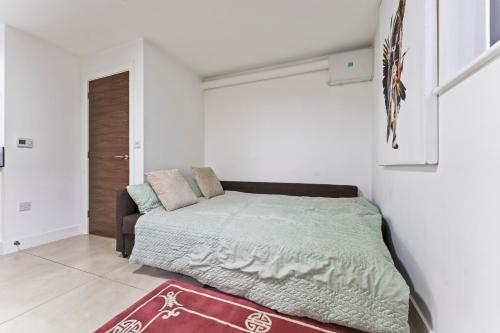 a bedroom with a bed in a white room at Bloom Court -Sleeps 6-Free Parking with Workspace & High-Speed WiFi in Birmingham