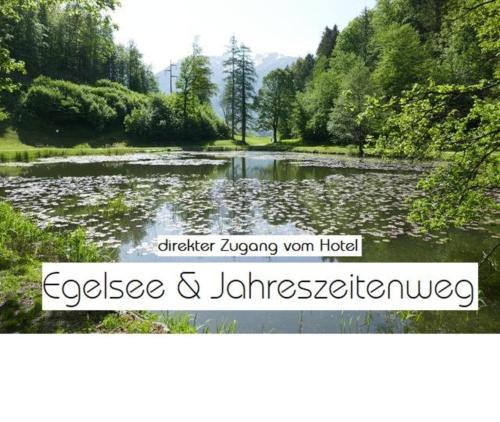 a sign for a lake with trees and water at Hotel Adler in Golling an der Salzach