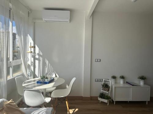 a white room with a table and chairs and a window at IRIVI 9 Apartment in Aguadulce