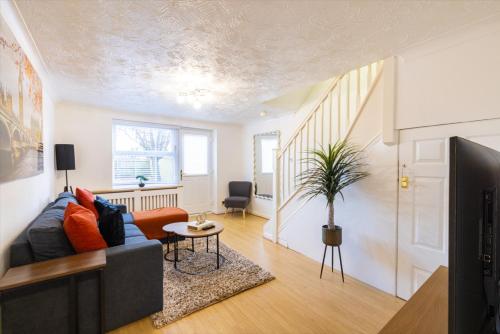 a living room with a couch and a table at SionStays - Honeysuckle Court - Close to City Centre! in Peterborough