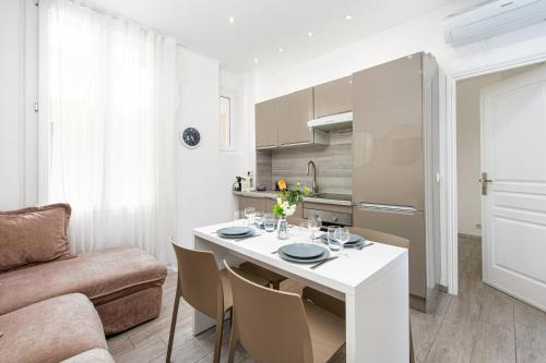 un salon avec une table blanche et un canapé dans l'établissement Le provence, à Beausoleil