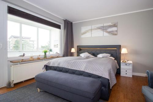a bedroom with a bed and a blue couch at Atlantic 209 in Döse
