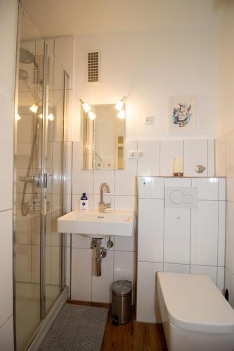 a bathroom with a sink and a toilet and a shower at Atlantic 209 in Döse