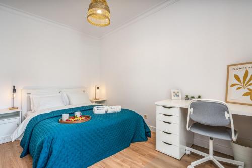 a bedroom with a bed and a desk and a chair at HostWise - Elegant & Stylish Flat w/ Balcony in Portimão