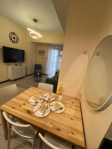 a wooden table in a living room with a dining room at Manila bay best staycation in Manila