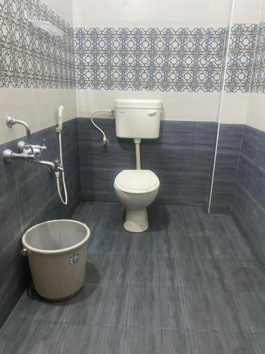 a bathroom with a toilet and a bath tub at Rustiic Paradise Private Villa in Puducherry Airpoert