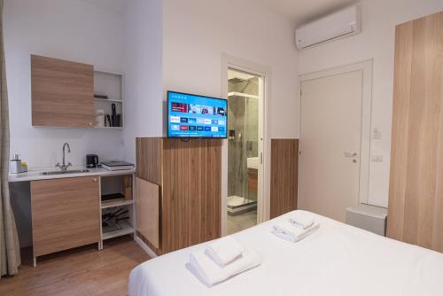 a room with a bed and a sink and a television at Residence San Paolo in Rome