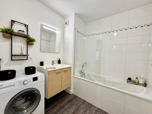 a white bathroom with a washing machine and a sink at Le Gregorien, Centre de Saint Gregoire in Saint-Grégoire