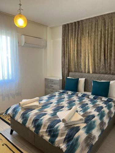 a bedroom with a large bed with towels on it at Huge Evleri 2 in Marmaris