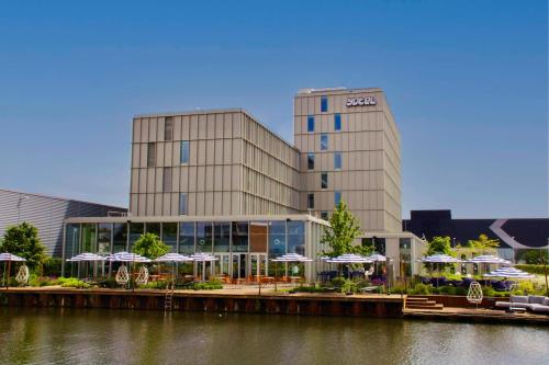 a large building with umbrellas in front of it at YOTEL Amsterdam in Amsterdam