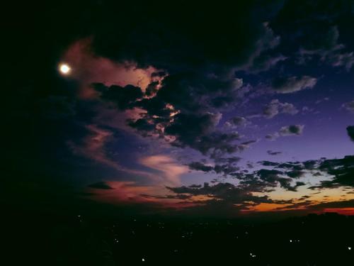a sunset with the moon in the sky at Nature Sanctuary Stay in Jutogh