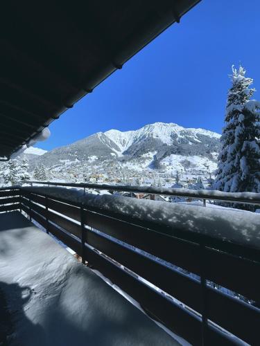 a view of a snowy mountain from a bridge at Chalet Dagmar in Klosters