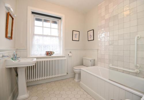 a bathroom with a tub and a toilet and a sink at Elizabeth Fort in Cork