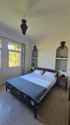 a bedroom with a large bed in a room at Villa vue mer imprenable- charme et tranquillité in Sidi Boulfdail