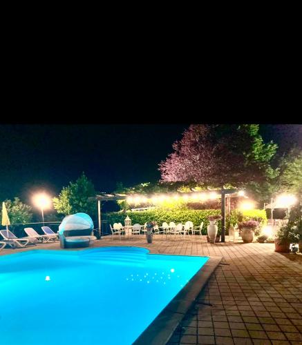 a swimming pool in a yard at night at Cascina Manzo in Dogliani
