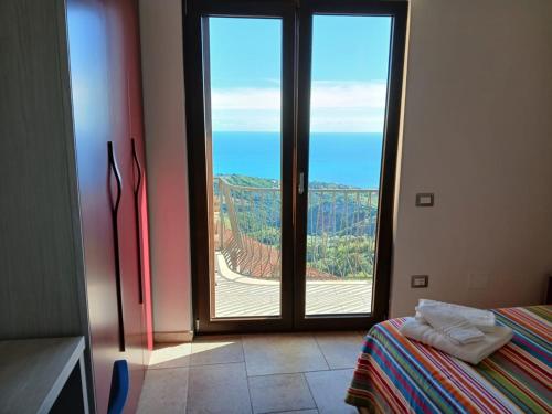 a room with a large glass door with a view at B&B Civico 31 in Pollica