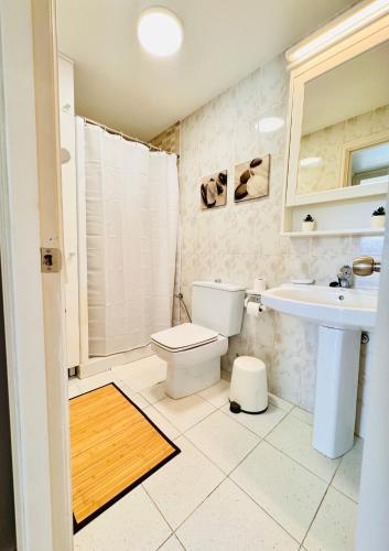 a bathroom with a toilet and a sink at Atlantic Ocean & Beach Views - Playa Del Cura in Las Palmas de Gran Canaria