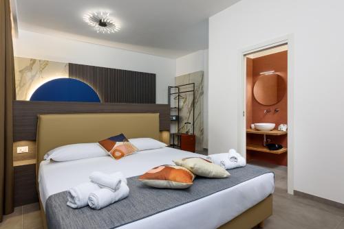 a bedroom with a bed with towels on it at Bedda Luna B&B in San Vito lo Capo