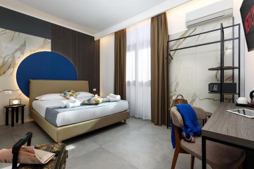 a hotel room with a bed and a table and chairs at Bedda Luna B&B in San Vito lo Capo