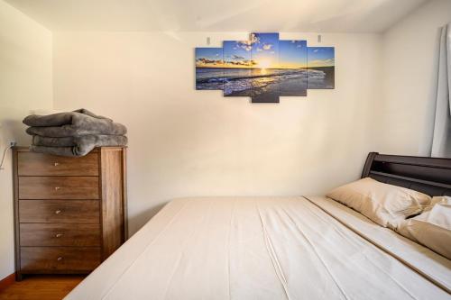 a bedroom with a bed and a painting on the wall at BEST Large Private Room & Private Bathroom in Queens