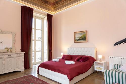 a bedroom with a large bed with a red blanket at ETNA QUEEN luxury home in Catania