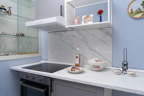 a white kitchen with a sink and a counter top at ETNA QUEEN luxury home in Catania