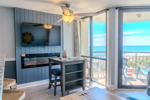 a living room with a table and a view of the ocean at Ocean View Double Suite! Sleeps 4 Meridian Plaza 705 in Myrtle Beach