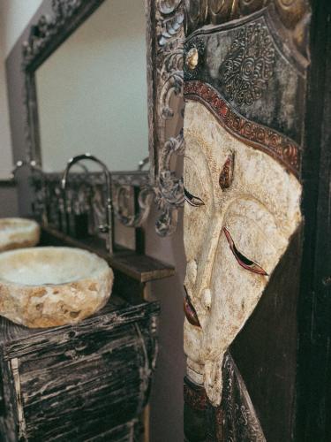 a mirror on a wall next to a sink at Il Fienile B&B in Guastalla