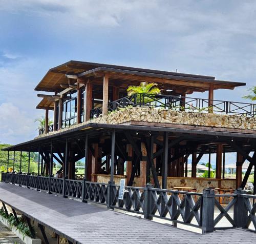 a wooden building on a pier next to the water at Hotel El Cielo en la Tierra in Quimbaya