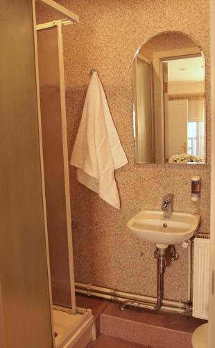 a bathroom with a sink and a mirror at Tenisa klubs Jūra in Jūrmala