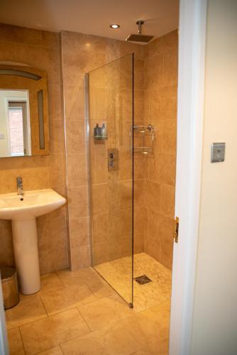 a bathroom with a shower and a sink at Highcross Corner in Poulton le Fylde