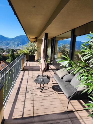 a balcony with couches and a table on a building at Levita Living Wolke in Merano