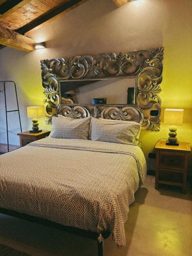 a bedroom with a large bed with a wooden headboard at Il Fienile B&B in Guastalla
