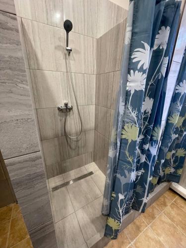 a shower in a bathroom with a shower curtain at uaHOSTEL in Kyiv