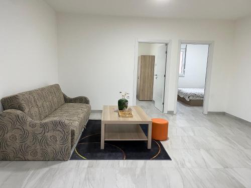 a living room with a couch and a table at Airport Art Villa in Surčin