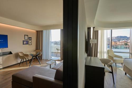 a living room with a couch and a table at Radisson Blu Hotel, Bergamo ChorusLife in Bergamo