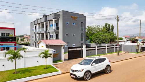 a white car parked in front of a building at RS Royal Executive Luxurious 3BR Apartment F3-3 and 2BR Apartment F3-2 in Pantang