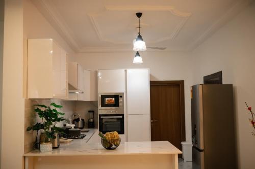 a kitchen with a refrigerator and a counter top at RS Royal Executive Luxurious 3BR Apartment F3-3 and 2BR Apartment F3-2 in Pantang