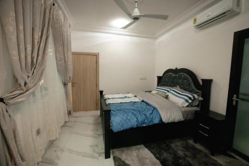 a bedroom with a bed and a window at RS Royal Executive Luxurious 3BR Apartment F3-3 and 2BR Apartment F3-2 in Pantang