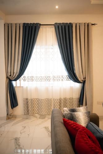 a living room with a couch and a window at RS Royal Executive Luxurious 3BR Apartment F3-3 and 2BR Apartment F3-2 in Pantang
