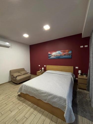 a bedroom with a large bed and a couch at A casitta in Giardini Naxos