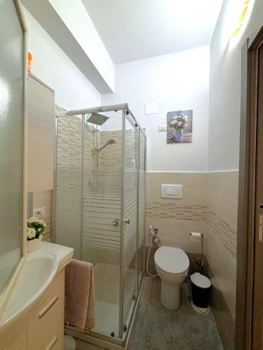 a bathroom with a shower and a toilet and a sink at A casitta in Giardini Naxos