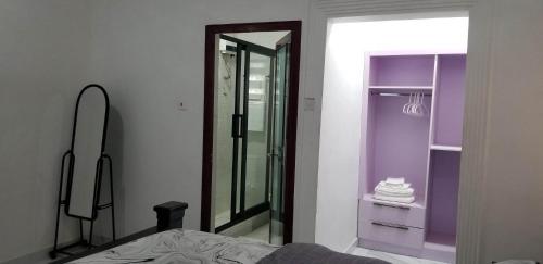 a bedroom with a mirror and a walk in shower at RS Royal Executive Luxurious 3BR Apartment F3-3 and 2BR Apartment F3-2 in Pantang